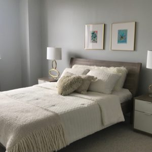 bedroom white comforter wooden headboard