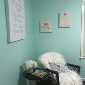 white fuzzy chair in teal room